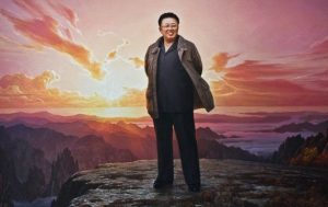 A large portrait of Kim Jong ll standing atop Mount Paektu at sunset. Birtjday of Kim Jong-Un