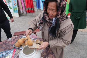 "Grandmother Makgeolli" prepares bowls of the fermented rice drink for tourists.