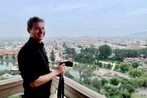 Making a North Korea documentary: Justin Martell overlooking a North Korean city.