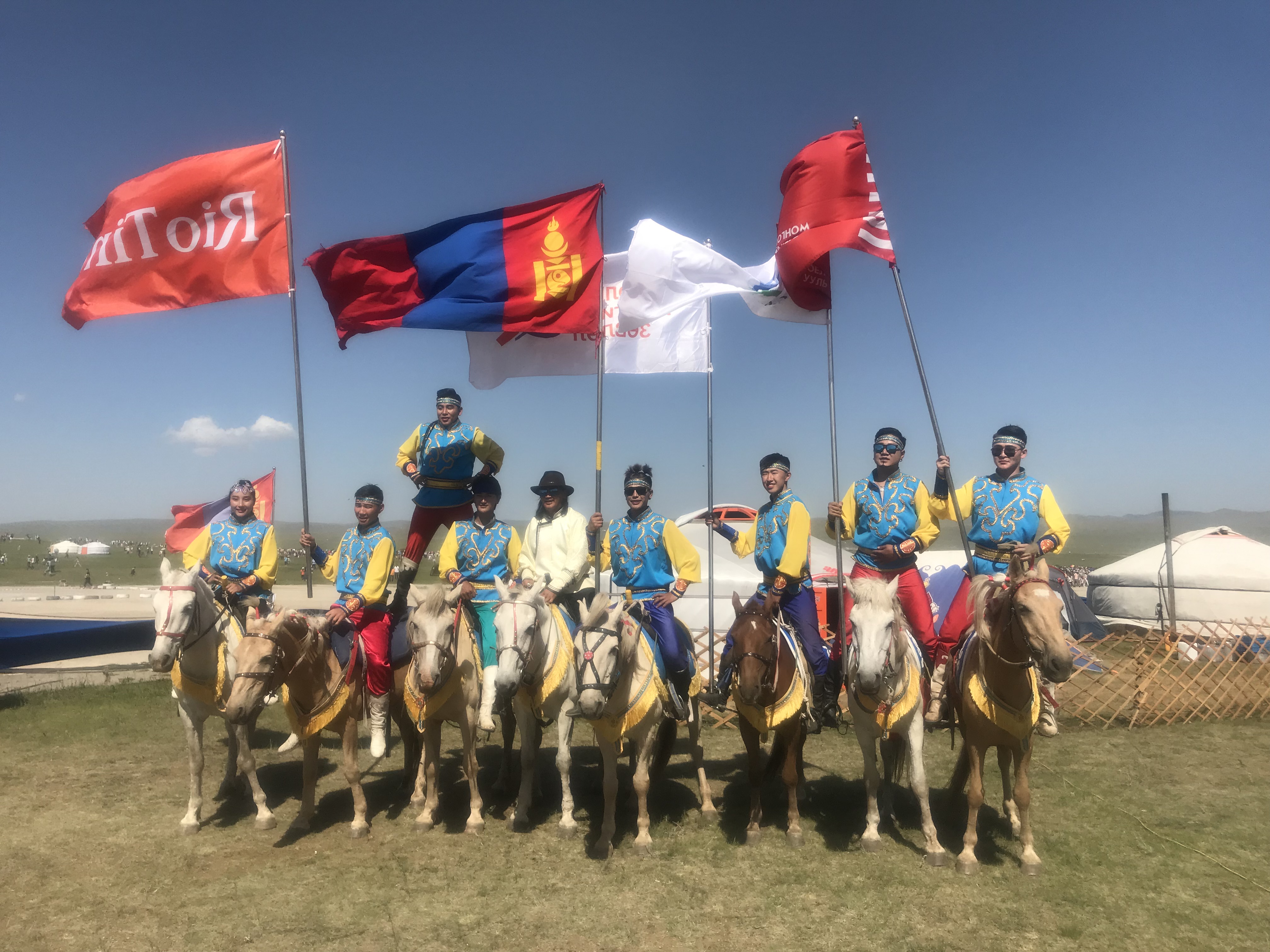 A group of Mongolian riders pose after a Mongol horse race.