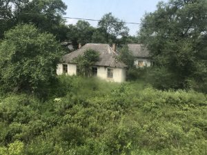 An abandoned building is overgrown with weeds at Tumangang, North Korea.