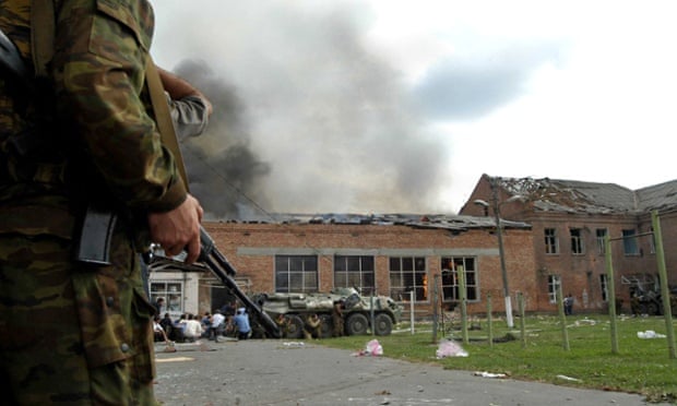 A Russian soldier stands outside Beslan school, North Ossetia, during the standoff with Islamic militants.